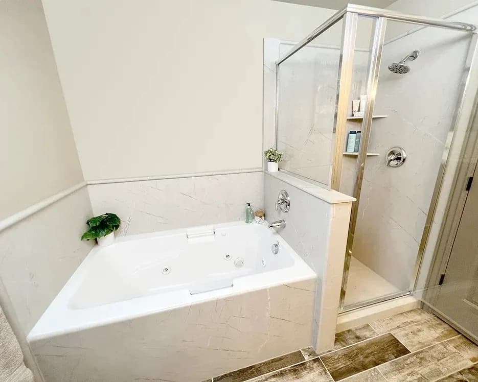 White bathroom with bathtub and walk-in shower.