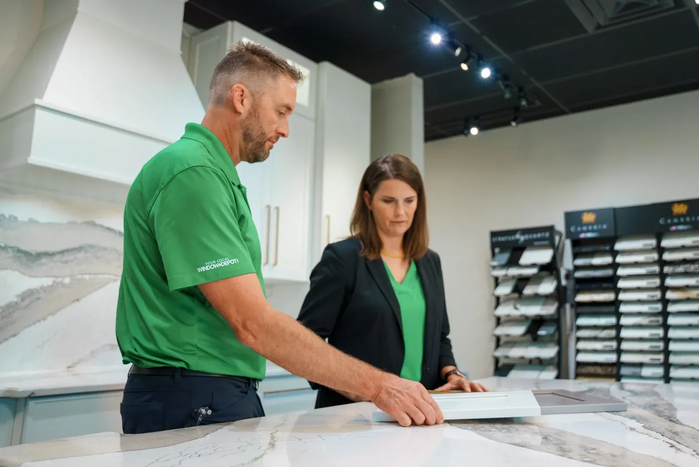 The husband/wife team behind the Twist & Spout company in their Springdale design center looking at different materials.