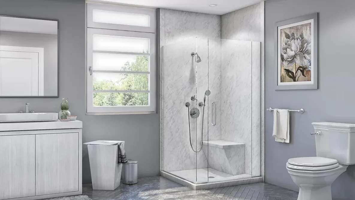 A newly remodeled bathroom with a beautiful new walk-in shower installed by Twist & Spout with glass walls, a seat, and chrome hardware.